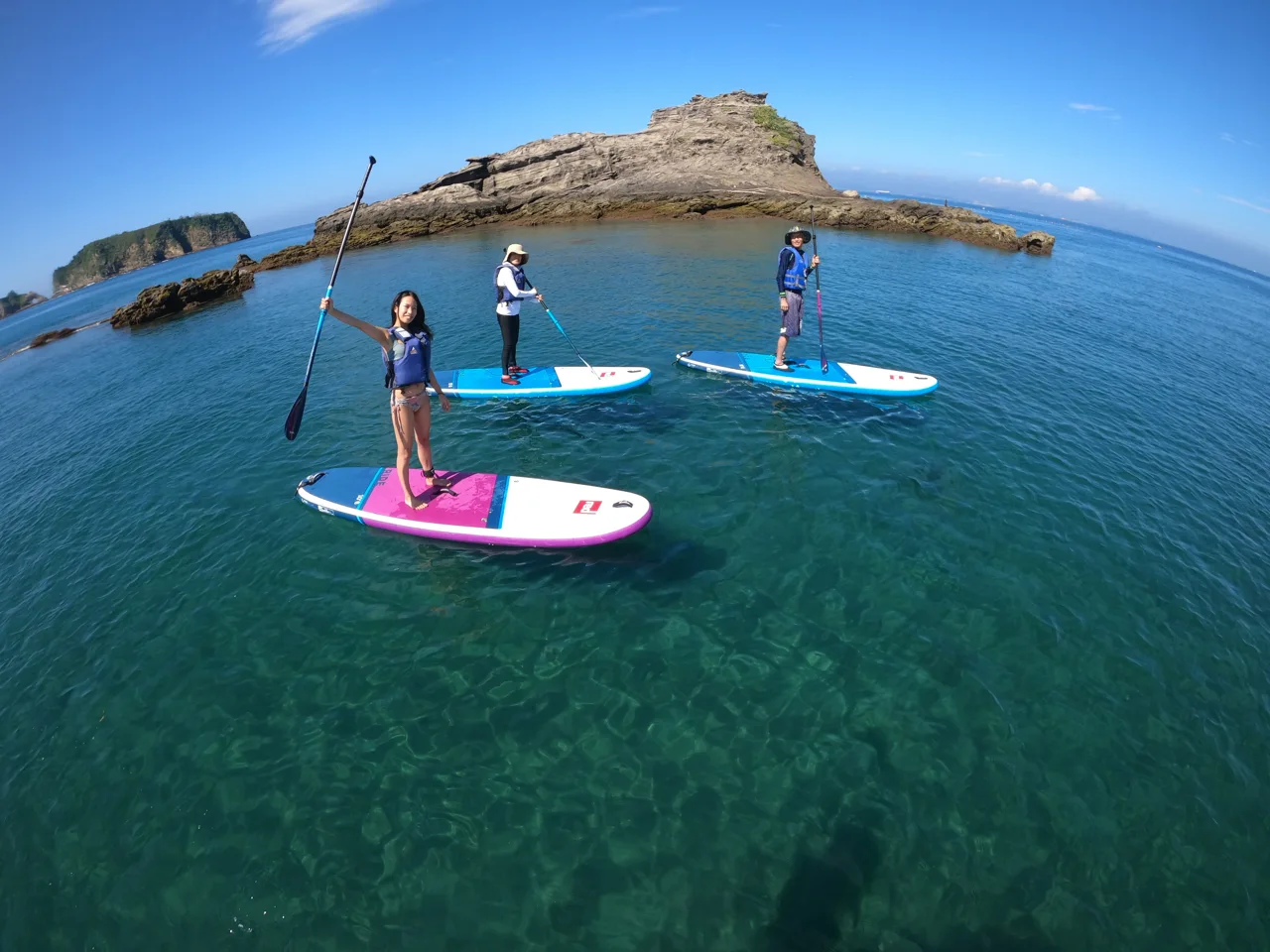 青い海でSUPを楽しむ参加者